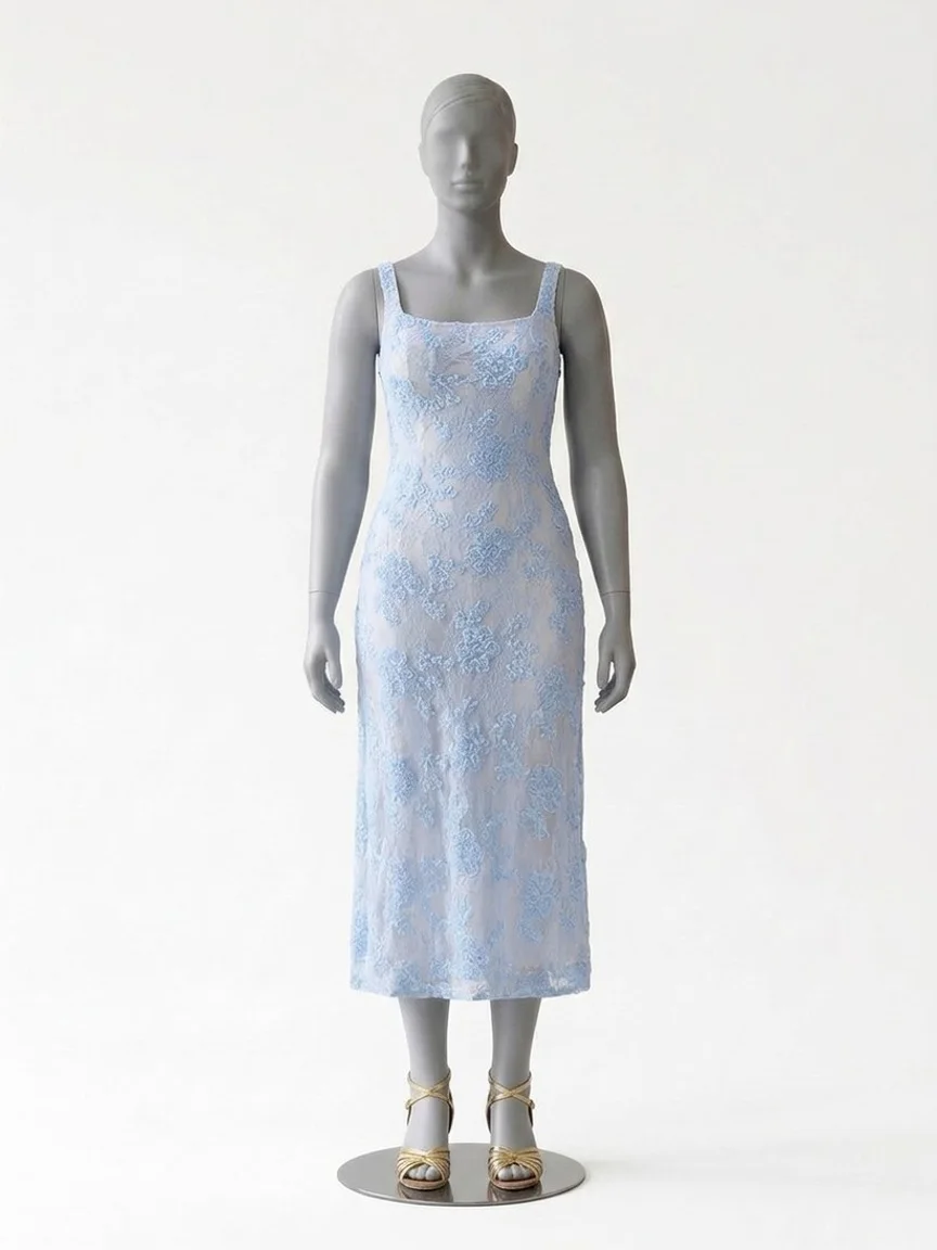 AI try-on render of the Zapaka light blue floral sheath midi dress with gold sandals on our size 12 mannequin