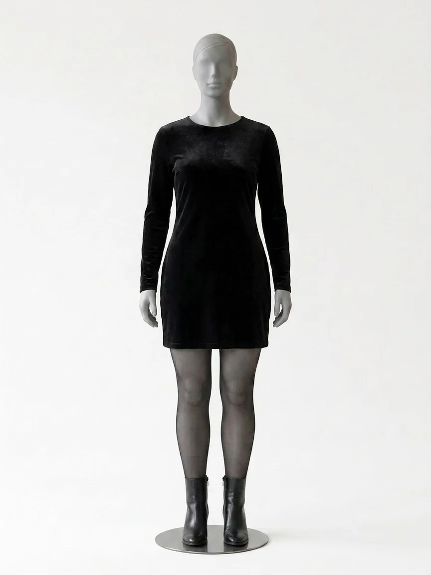 AI render of a black velvet mini dress with sheer black tights and heeled ankle boots on our size 12 mannequin